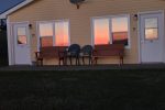 Sun setting over the ocean shining into the windows