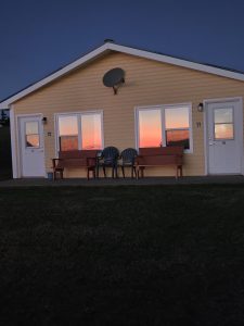 Sun setting over the ocean shining into the windows